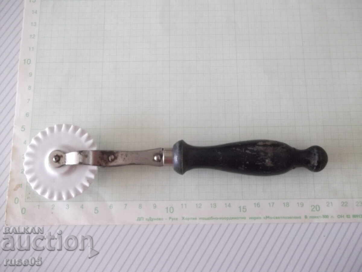 Dough cutter with porcelain disc and wooden handle