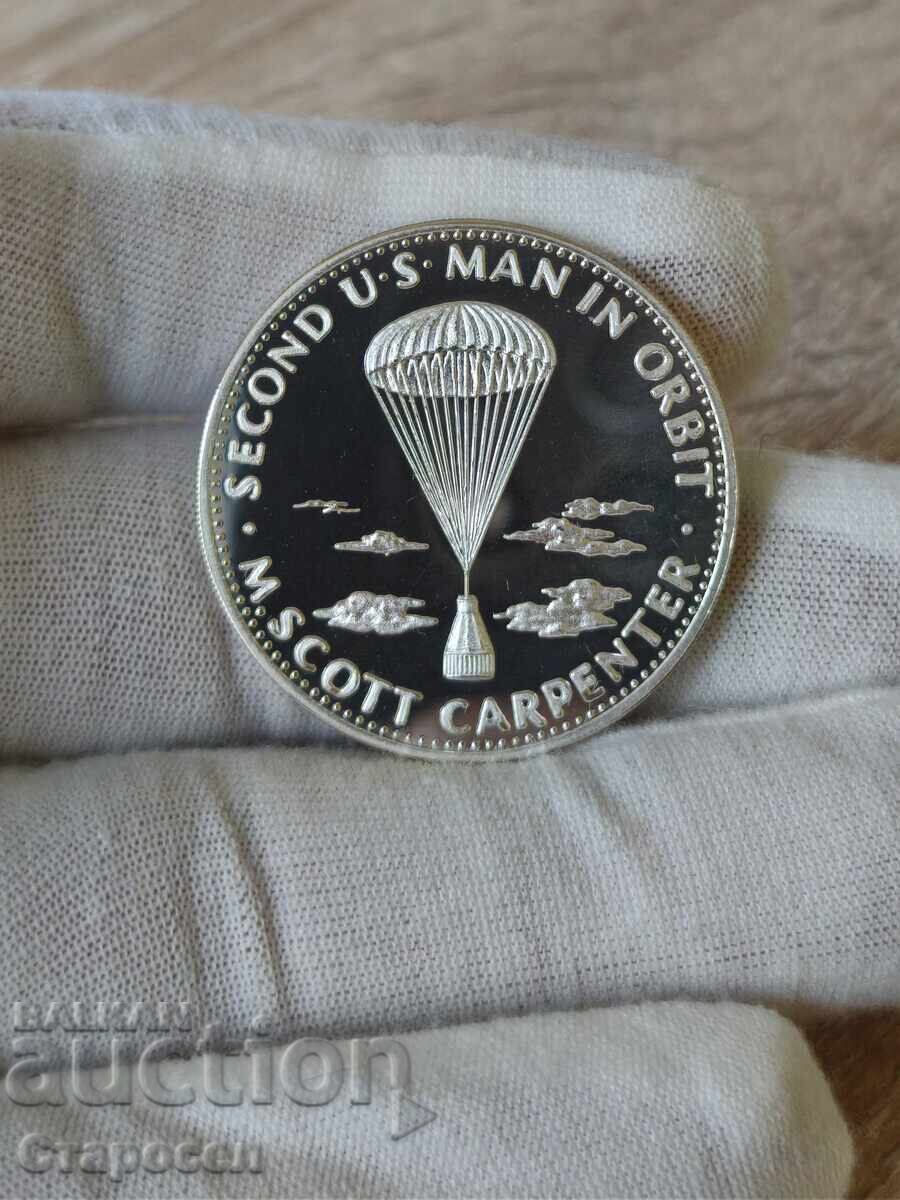 Νόμισμα (πλακέτα) "Ο δεύτερος Αμερικανός σε τροχιά" Νόμισμα (πλακέτα) "Ο δεύτερος Αμερικανός σε τροχιά"