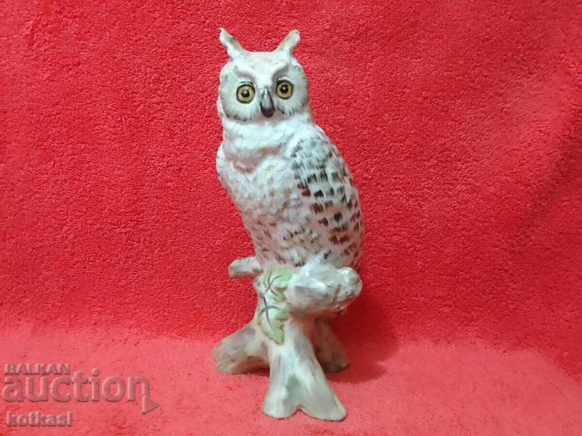 Colorful porcelain owl figure on a branch Colorful porcelain owl figure on a branch