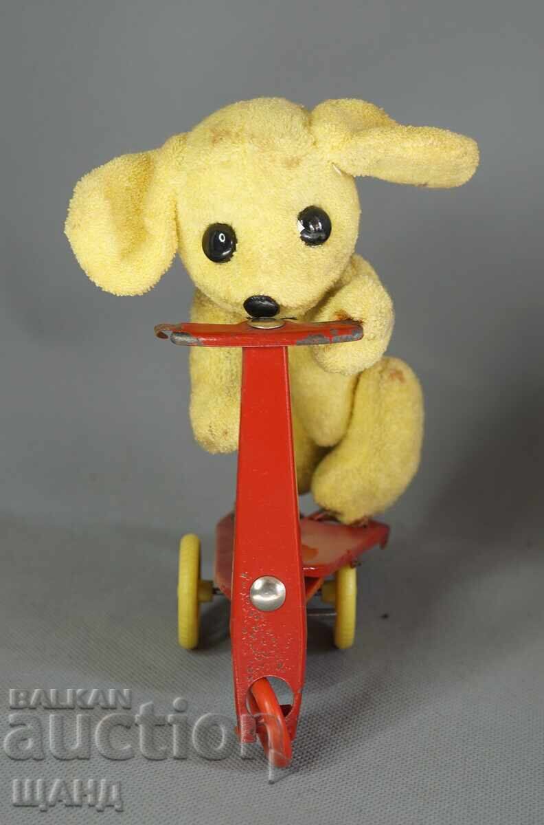 Old mechanical metal toy scooter model with dog