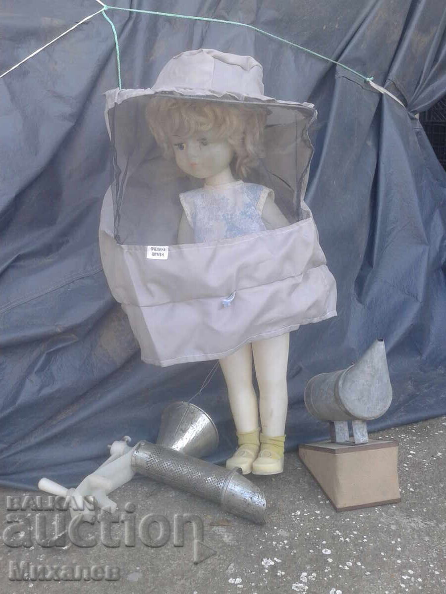 The little beekeeper with beekeeping equipment