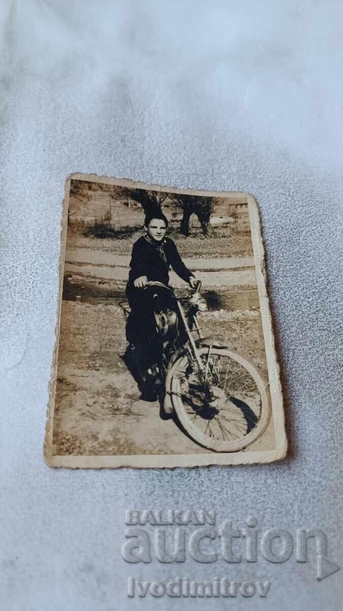 Photo of a Boy with a Retro Motorcycle Photo of a Boy with a Retro Motorcycle