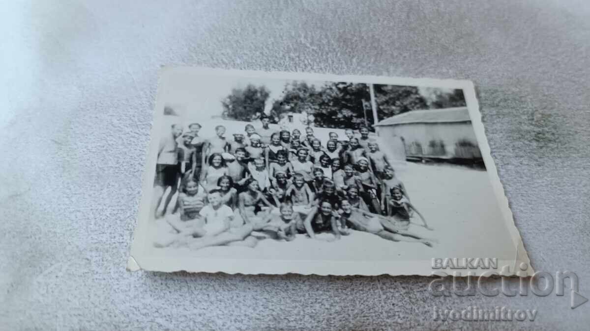 Photo of Men, Boys, and Girls on the Beach