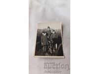 Photograph of a Border Guard with a border guard dog and two girls