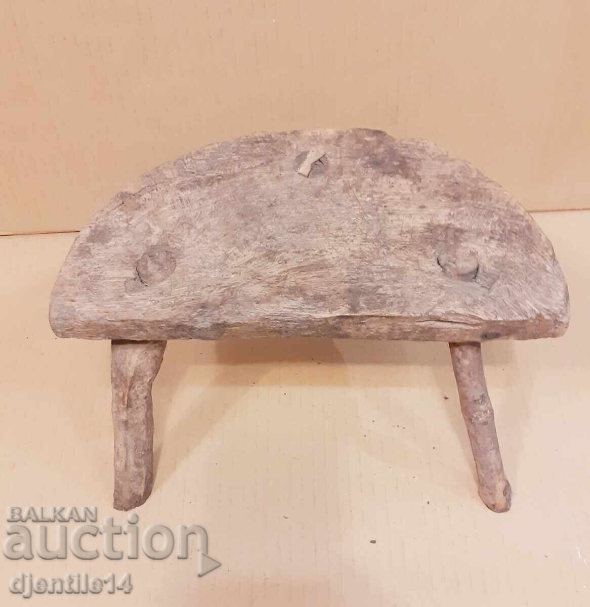 Three-legged wooden stool