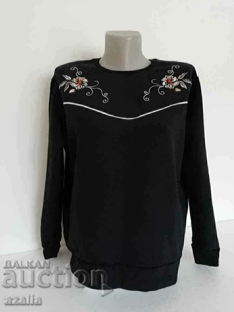 Black quilted blouse with two flower ornaments, size M
