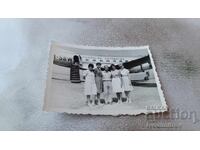C-car, Man and Four Women on the Runway in Front of a Lufthansa Plane