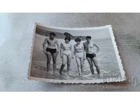 Photo of Young Men and Young Women on the Beach