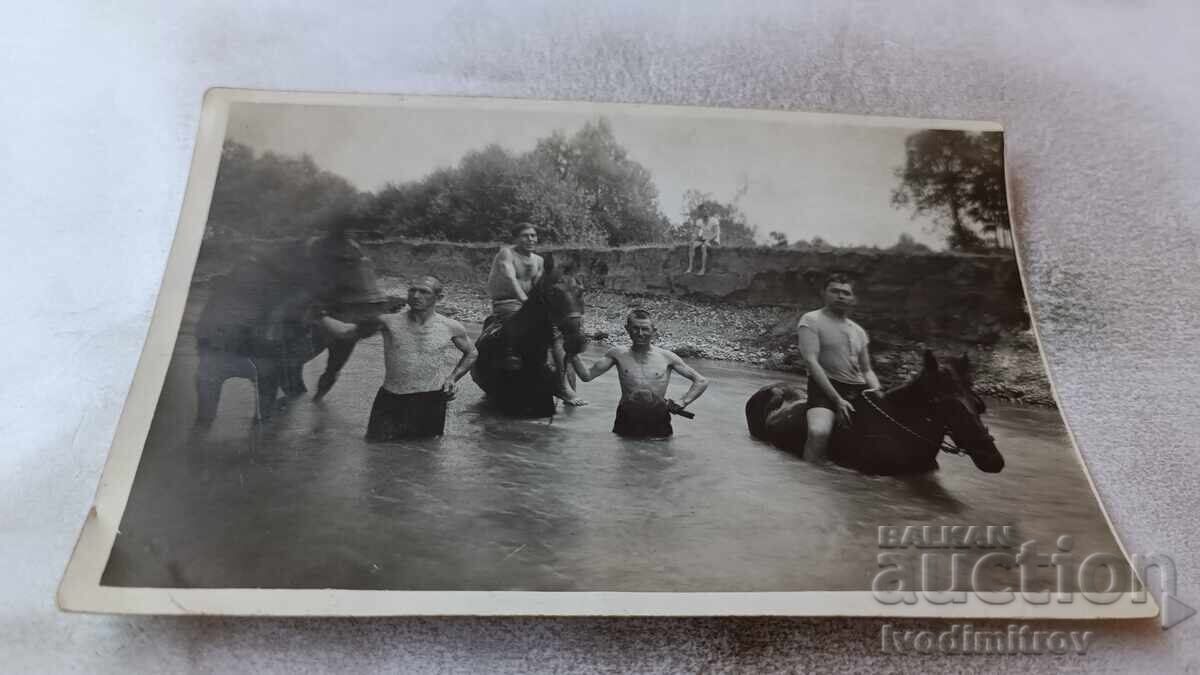 Photo Men and boys with horses in the river Photo Men and boys with horses in the river