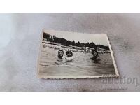 Photo: Man, woman, and little girl in the sea