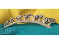 Six lucky elephants climbing a bridge