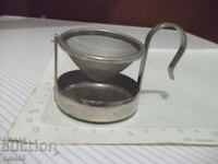 Tea strainer swing