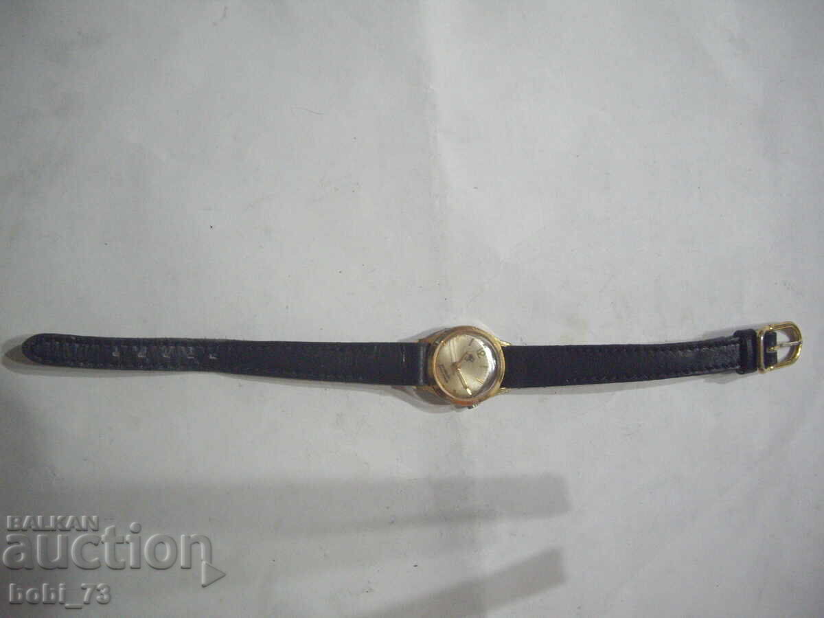 Old ladies gold watch.