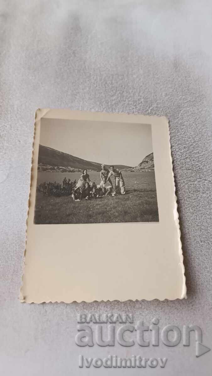 Photo of Pirin: Young men and women on a meadow near Lake Papaz-gyol