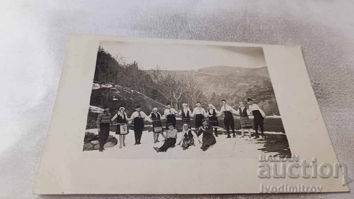 Photo of Young Men and Women Holding Hands in Winter