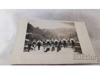 Photo of Young Men and Women Holding Hands in Winter