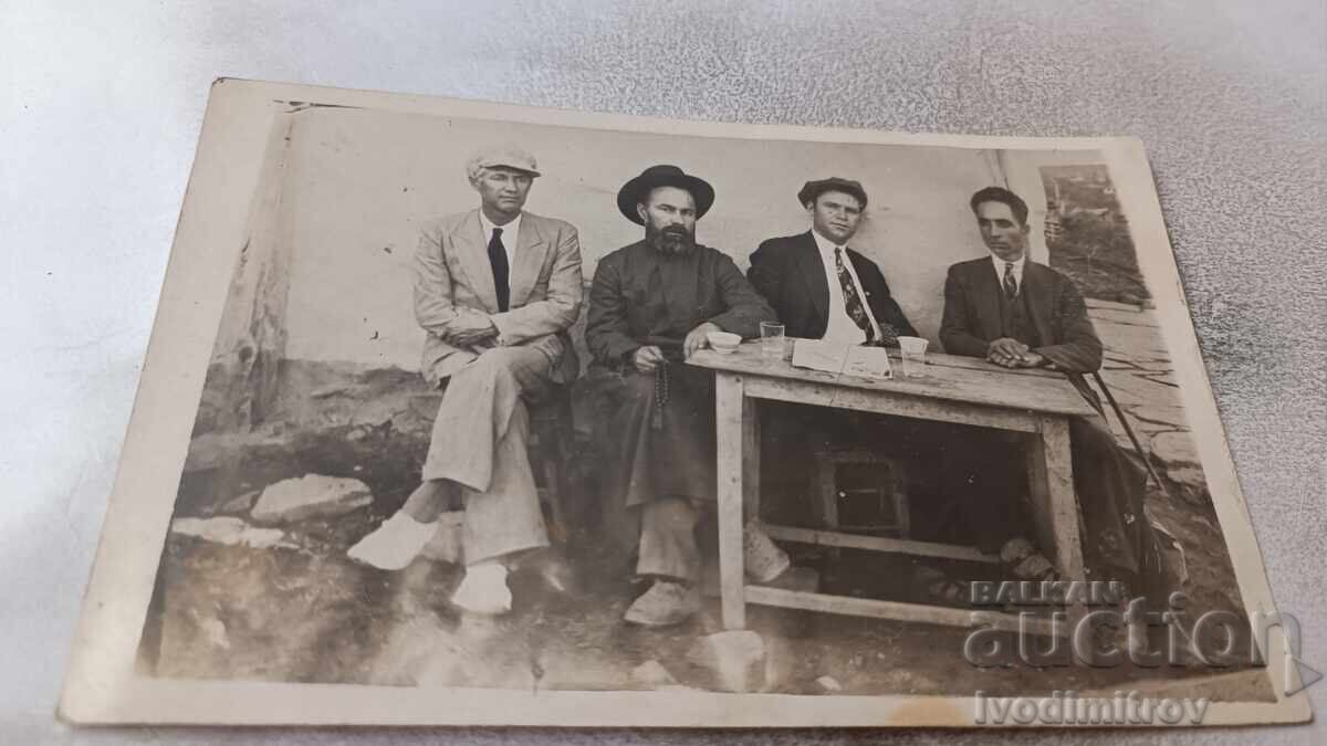 Photo of Three Men and a Spiritual Person Having Drinks