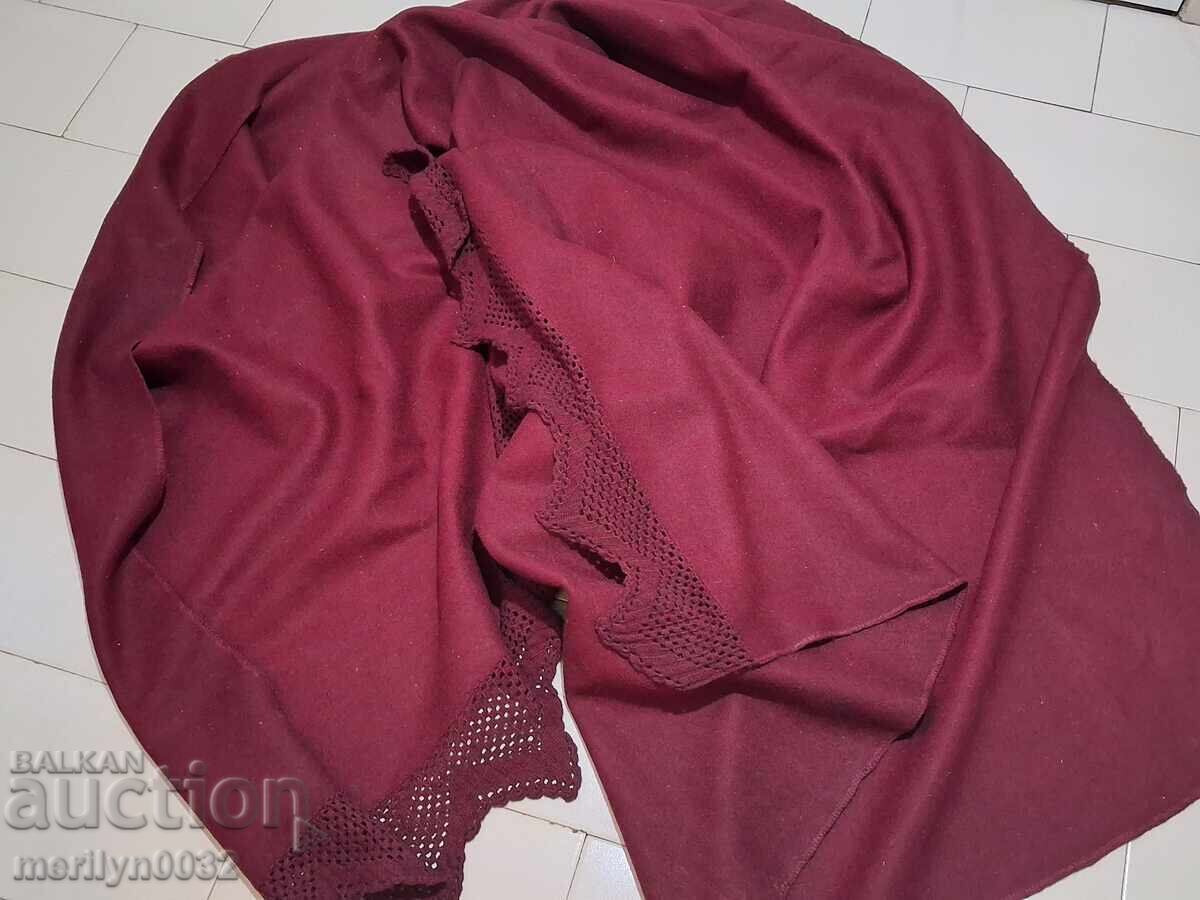 Old woolen bedspread of red felt with lace Old woolen bedspread of red felt with lace