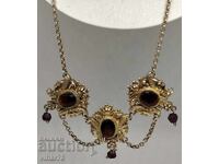 Old silver necklace with garnets and gilding