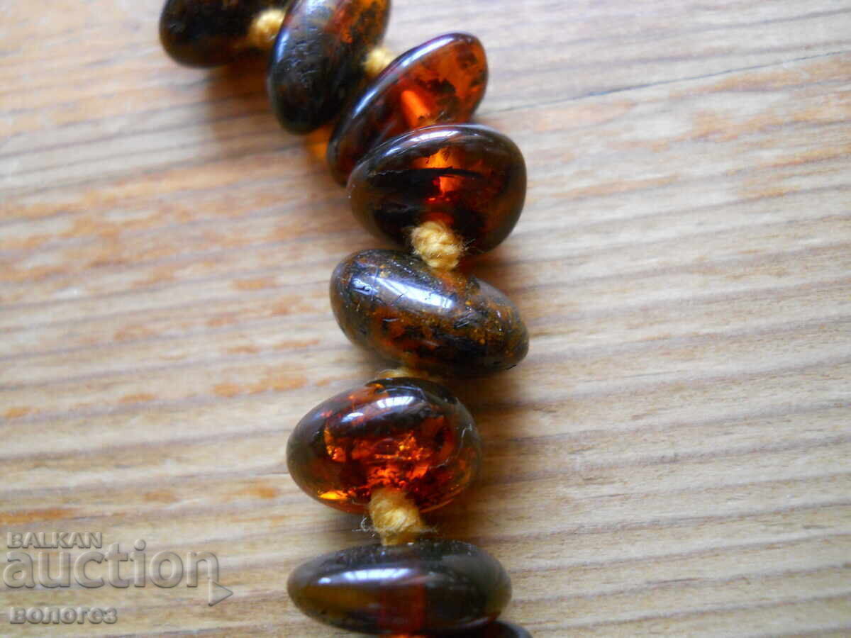 Auction Antique Baltic amber necklace with a silver clasp Auction Antique Baltic amber necklace with a silver clasp