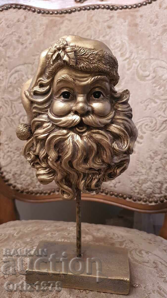 Златен Дядо Коледа на стойка– 26см Златен Дядо Коледа на стойка– 26см