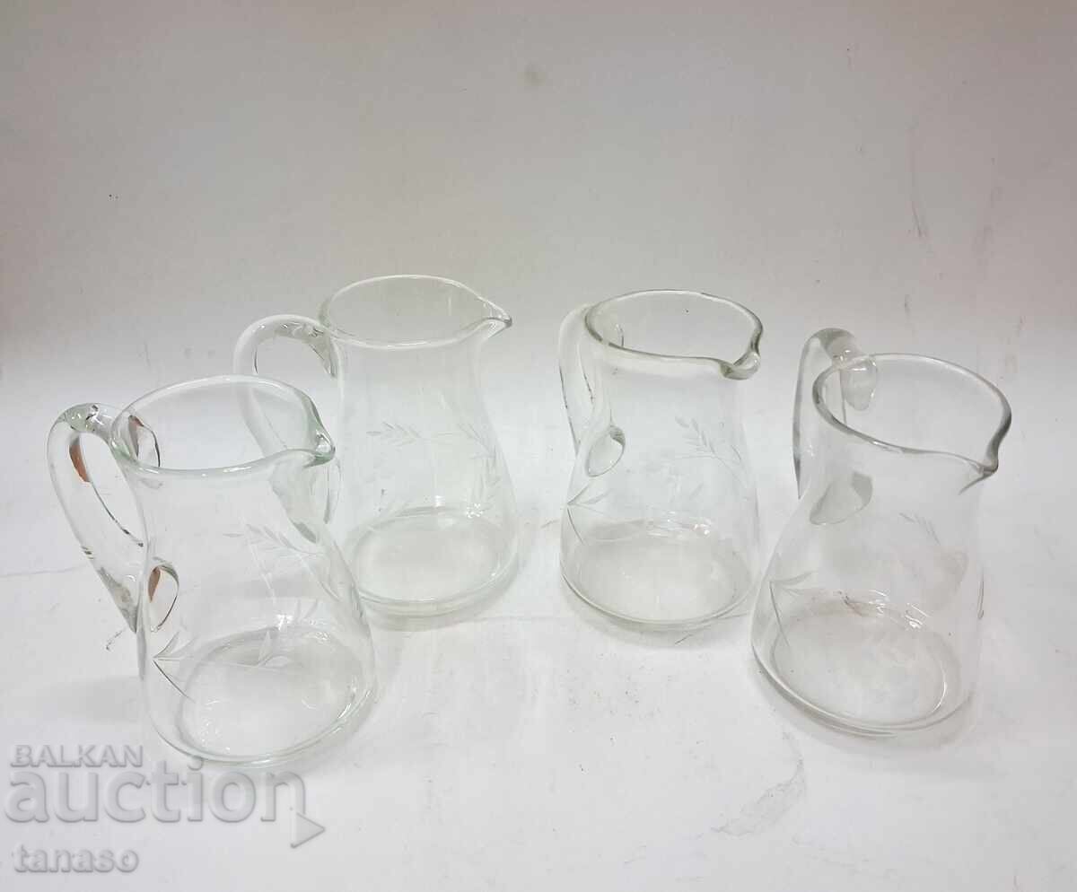 Auction  4 glass pitchers with engraved floral motifs