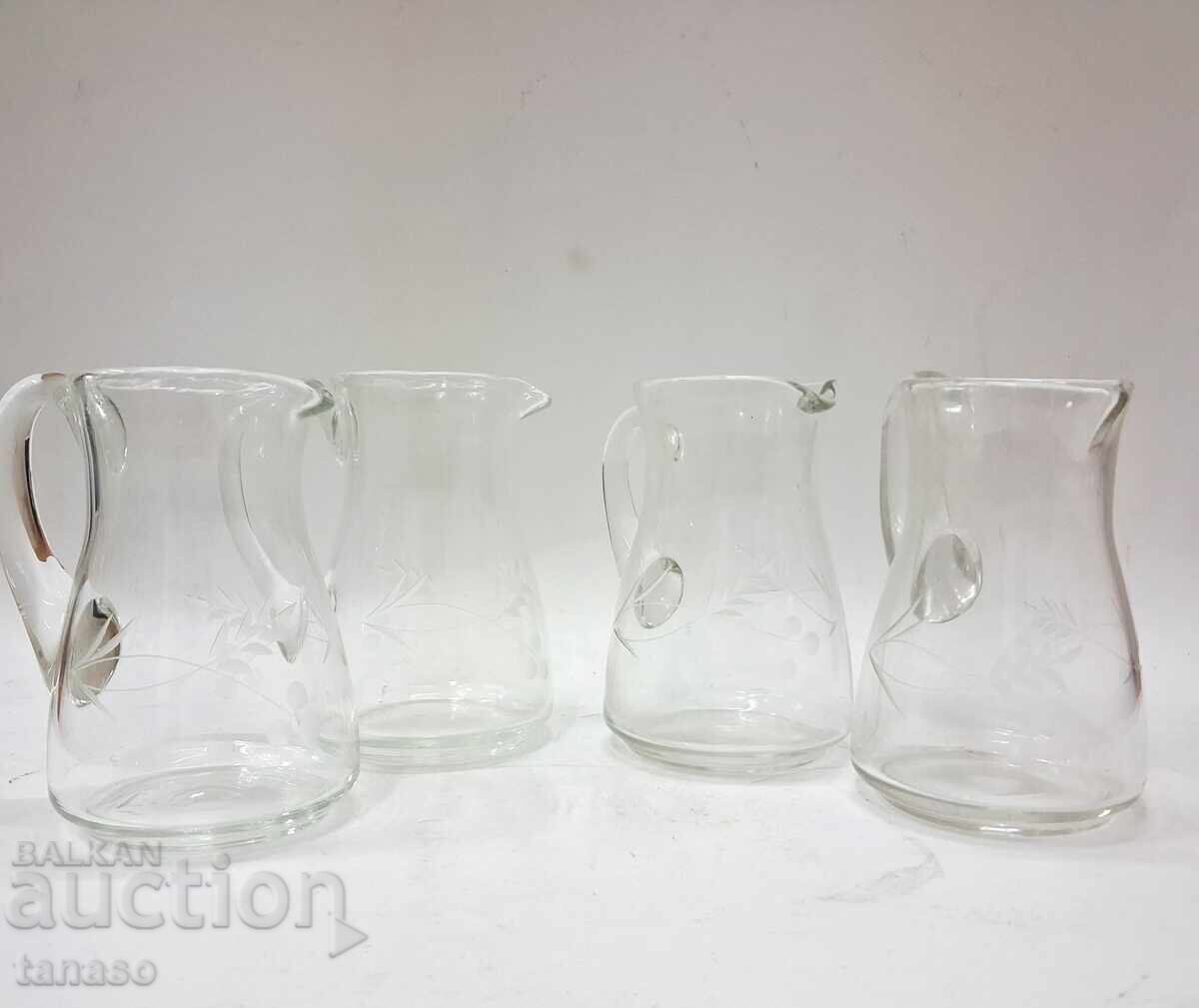 4 glass pitchers with engraved floral motifs