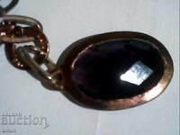 Old silver pendant with a large amethyst stone