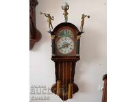 Dutch wall mechanical clock with Atlas figure and trumpet
