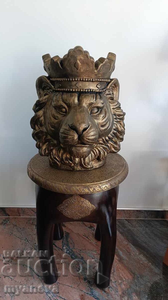 Lion with a crown, sculpture, symbol of strength and confidence