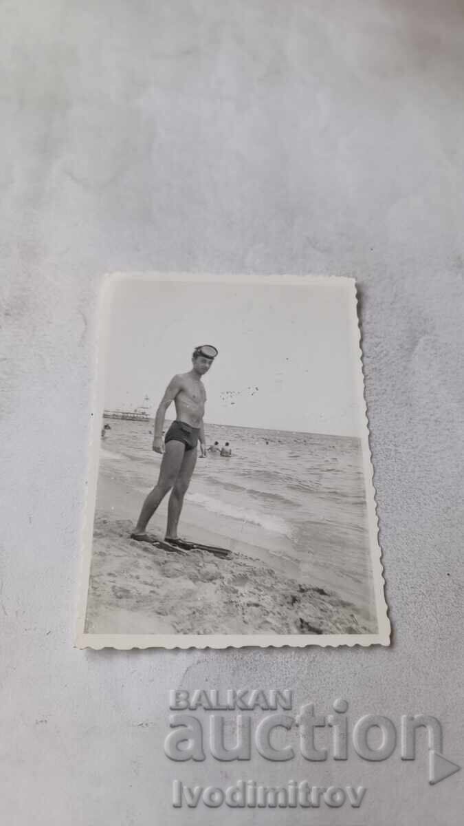 Photo of a Young Man with Flippers on the Beach Photo of a Young Man with Flippers on the Beach
