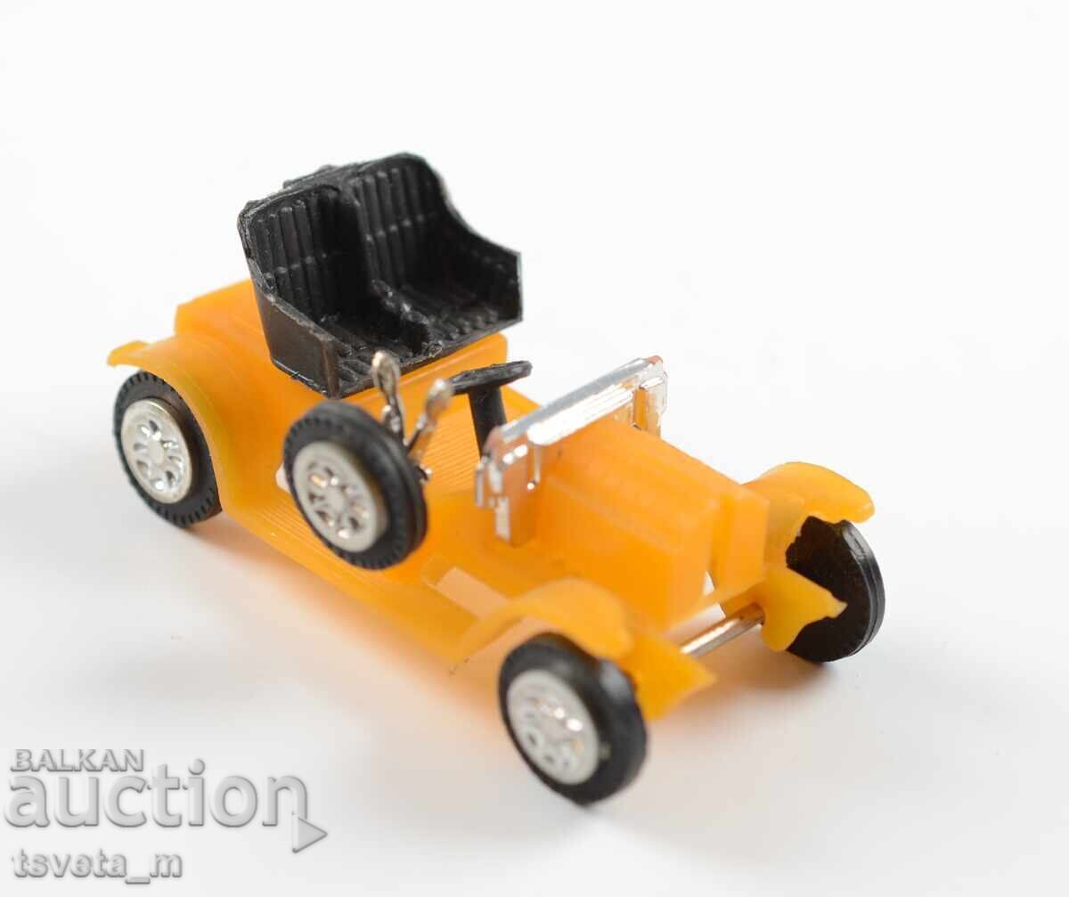 Plastic toy car model of an antique car