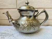 Beautiful teapot with flowers and colored metal markings