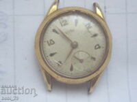 Стар дамски позлатен часовник.