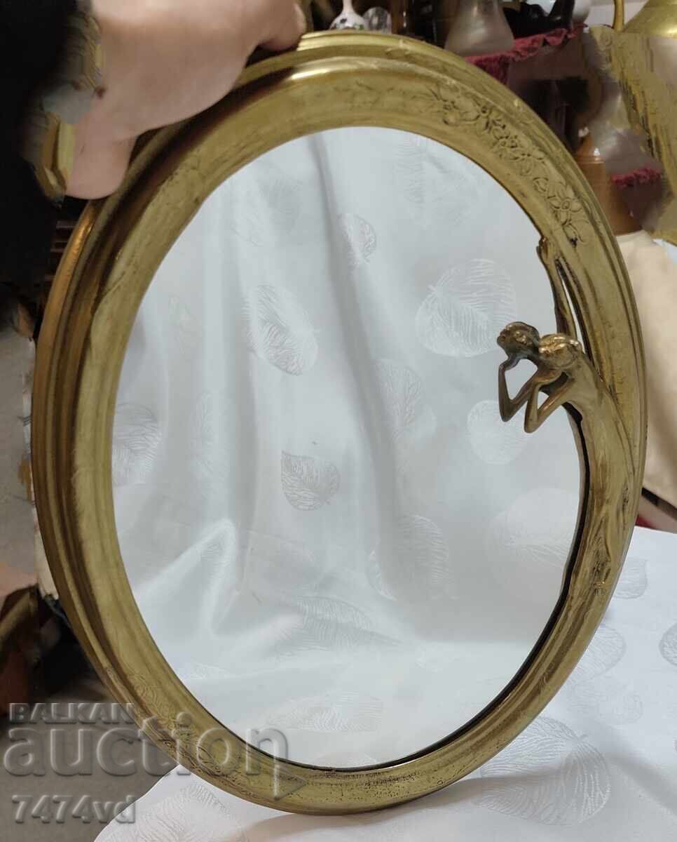 Antique table mirror with a woman looking at herself!