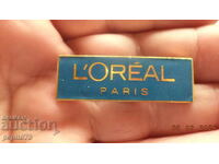 LOREAL PARIS badge, cosmetic company