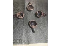 four different ceramic mugs