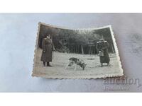 Photograph Two officers with a wolf-breed dog