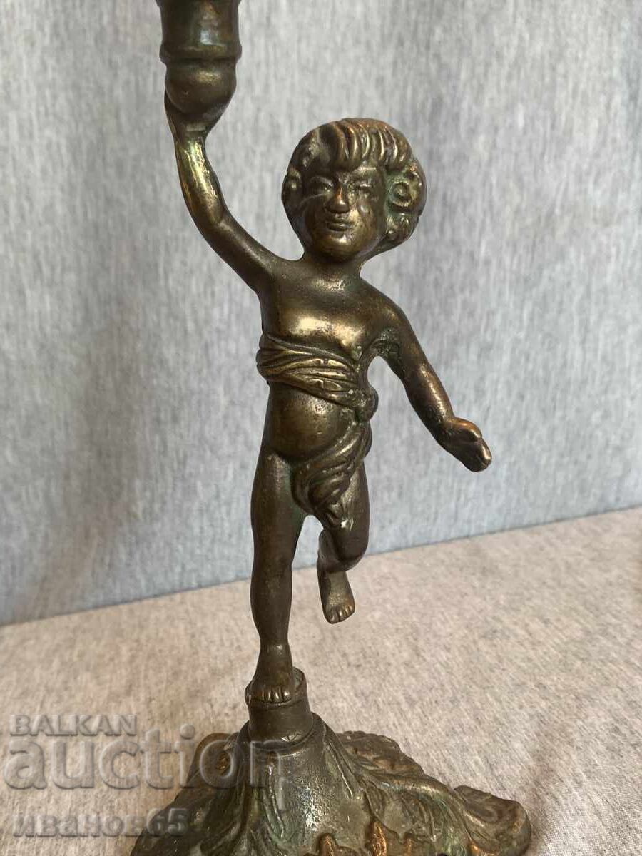 Brass candlestick holder for a candle with an angel