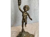Brass candlestick holder for a candle with an angel