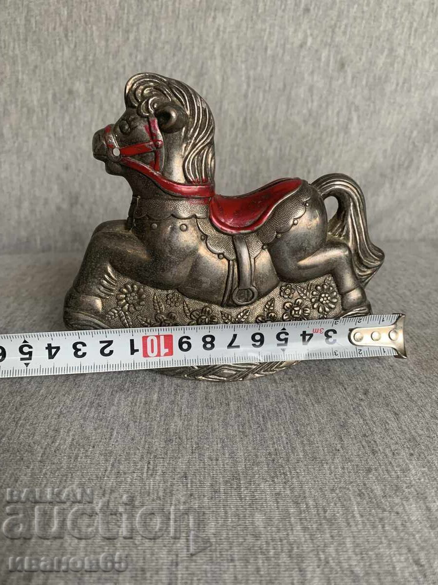 Auction  Coin bank in the shape of a rocking horse
