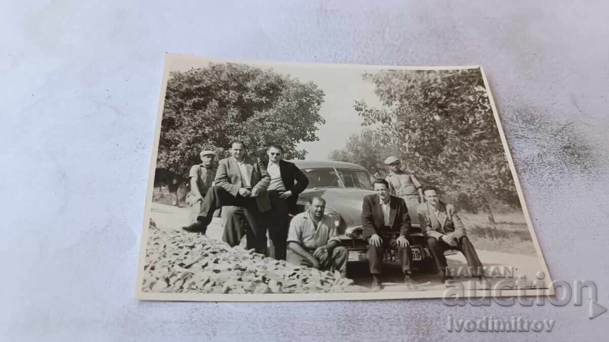 Photograph Men with a vintage car on the road