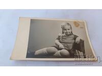 Photo of a little girl sitting on a chair