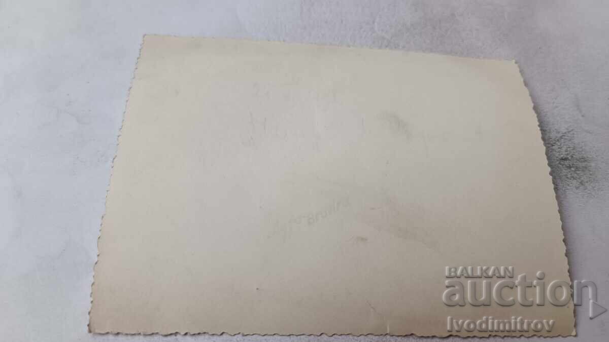 Auction  Photo of men, women, and children with a cart on the street