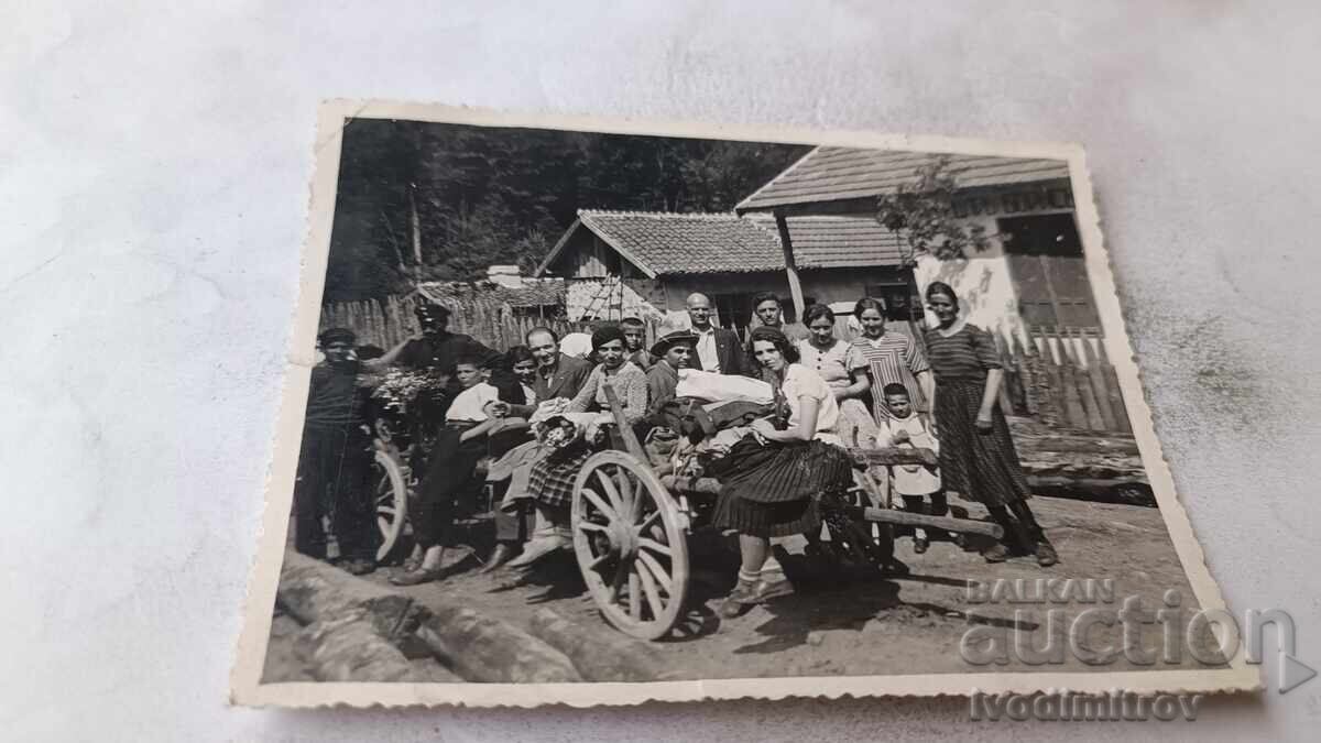 Photo of men, women, and children with a cart on the street