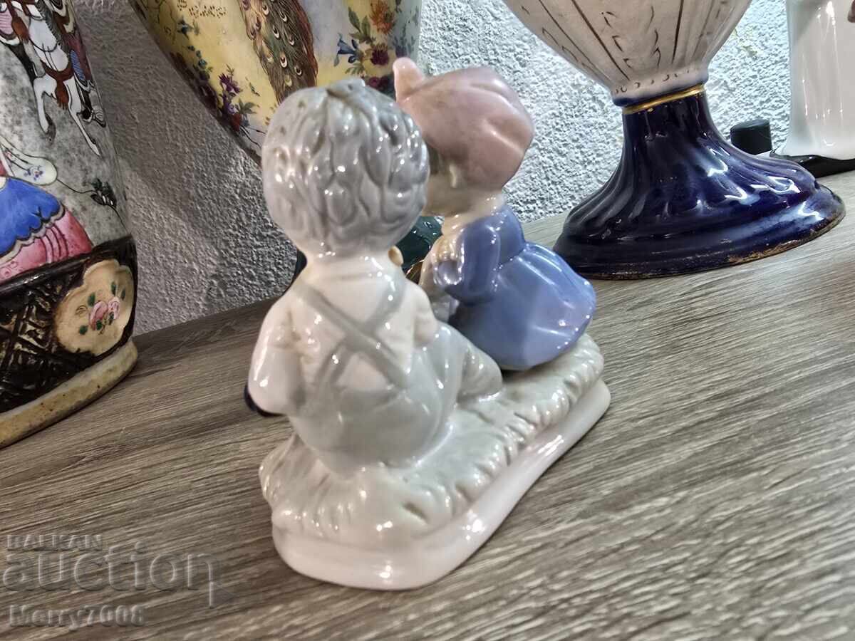 Auction  Collectible porcelain figurine depicting two small children