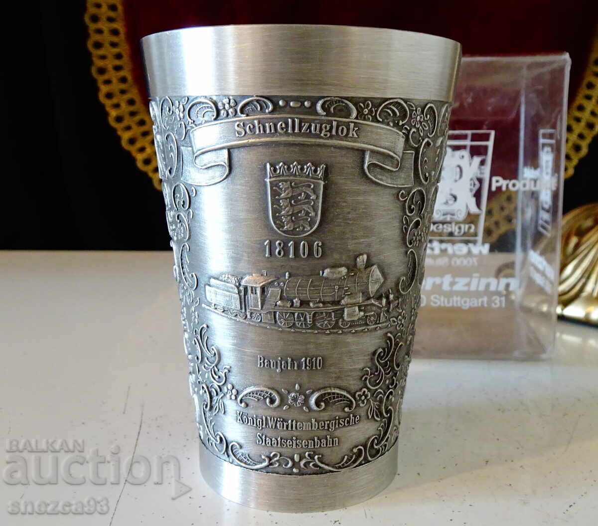 Auction  Tin cup with train, locomotive, box