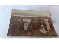 Photo of man, women and children in the vineyard