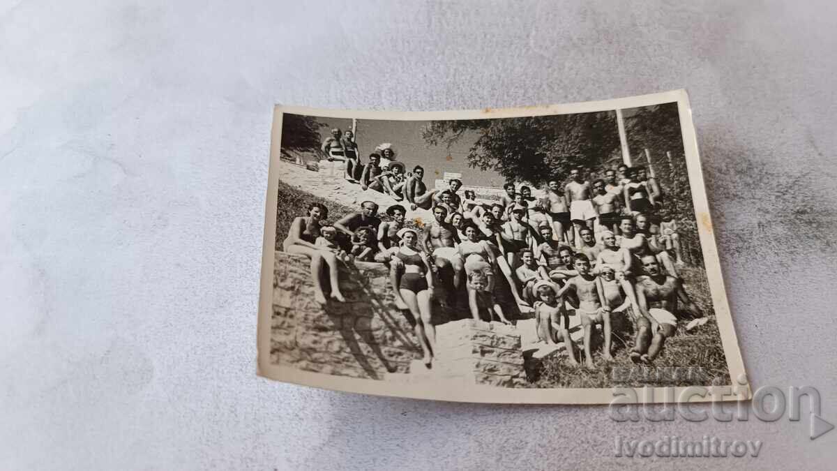 Fotografie bărbați, femei și copii pe scările către plajă