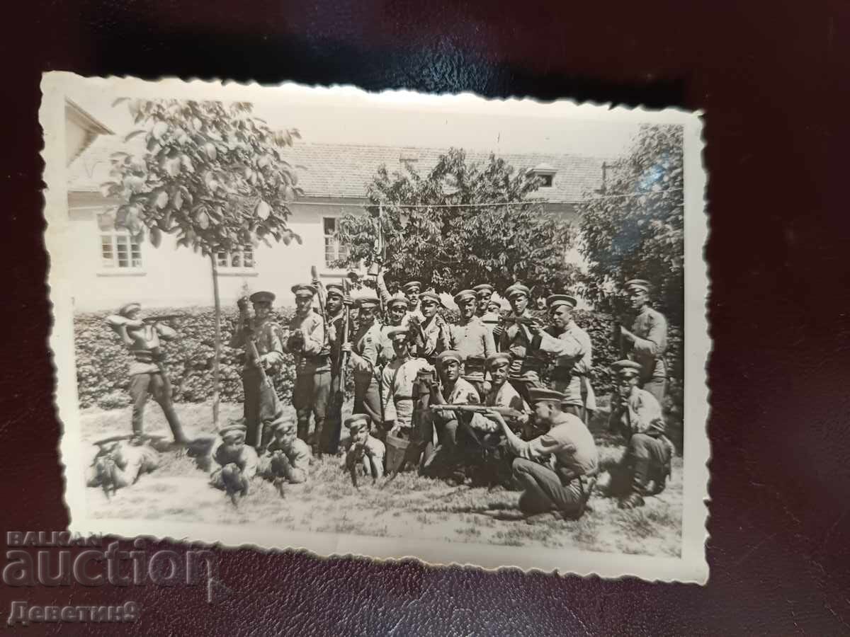 Armed soldiers in front of a military unit